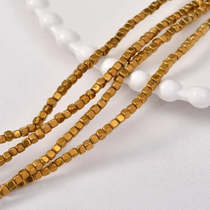 Macro detail of 3mm golden cube hematite beads for DIY jewelry making and crafts