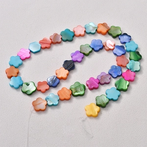 Colorful mother of pearl flower beads arranged in S-curve for DIY jewelry making