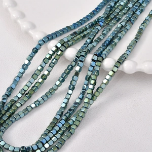 Close-up of 3mm aurora plated cube hematite beads with metallic blue-green gradient finish