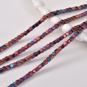 Macro shot of iridescent 3mm cube hematite beads for DIY jewelry making and crafts