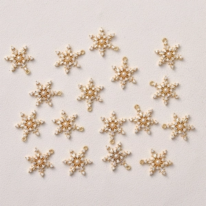 Detail of 14k gold plated snowflake charms with zircon and pearls for DIY jewelry