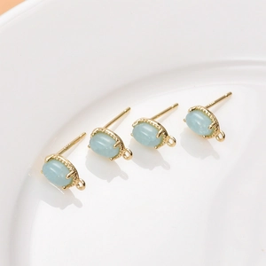 Detailed view of 18K gold-plated oval stud earring bases with S925 silver pins and blue stones