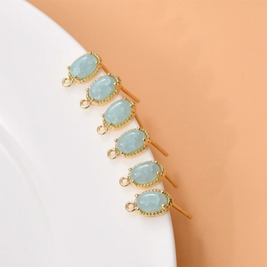 Oval light blue gemstone earrings with 18k gold plated frames and beaded edges