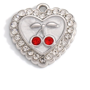 Macro shot of silver heart pendant with red cherry gems and pavé zircon border