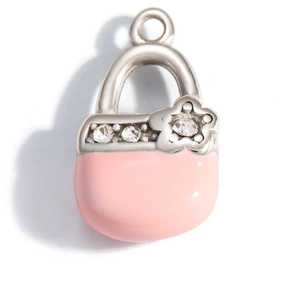Close-up of pink enamel handbag charm with cubic zirconia and silver metal handle