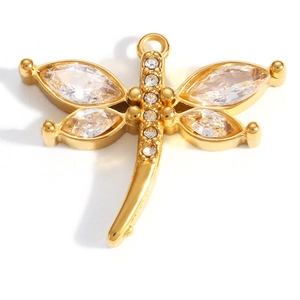 Macro detail of dragonfly charm with gold plating and marquise cut zircon wings