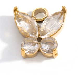 Macro shot of gold butterfly charm with clear marquise and round crystals for DIY jewelry
