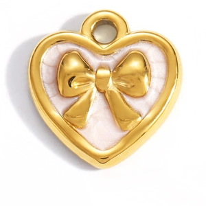 Detail of a gold heart pendant with pink cracked enamel and a small golden bow tie