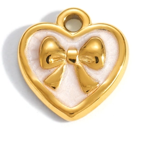 Macro view of gold heart pendant with pearlescent white inlay and 3D bow detailing