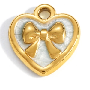 Close-up of gold heart pendant with pearl enamel texture and a 3D bow detail