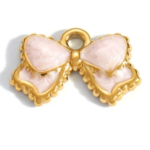 Close-up of pink bow-shaped enamel pendant with gold plating for DIY jewelry making