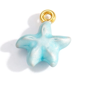 Detailed close-up of a blue starfish pendant with gold-plated ring and pearlescent finish