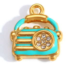 Detailed view of a gold-plated vintage radio pendant with blue enamel and sparkling crystals