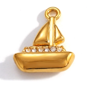 Detail of a gold-plated sailboat pendant featuring white zircon stones on the deck