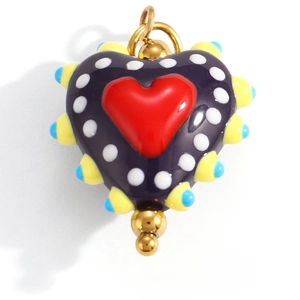 Macro shot of colorful heart pendant with red heart, white dots, and yellow-blue spikes