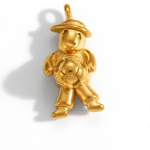Detail of a gold-plated charm featuring a figure holding a soccer ball with a polished finish
