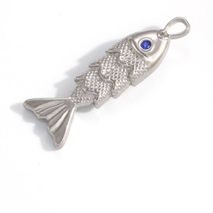 Detailed close-up of a silver fish pendant with textured scales and blue gemstone eye