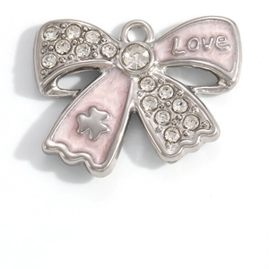 Detail of pink bow pendant with crystals, Love engraving, and stainless steel finish