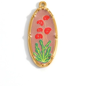 Detail showing vintage gold oval charm with pink enamel floral pattern and textured edge