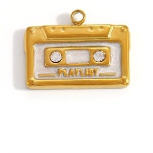 Macro shot of gold retro cassette tape pendant with playlist text and crystal accents