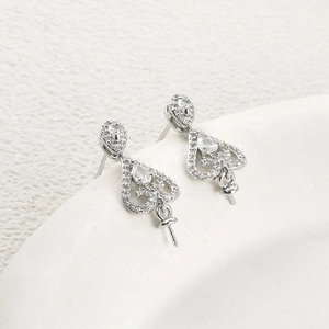 Detail of silver heart earring components with zircon inlay for DIY pearl jewelry making