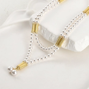 Double-layered pearl necklace with 14k gold-plated magnetic cylinders and diamond accents