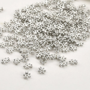 Close-up of snowflake shape spacer beads with small cubic zirconia for DIY jewelry