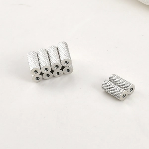 Macro detail of silver magnetic cylinder bead with knurled texture for jewelry making