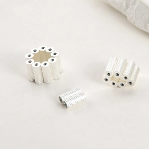 Macro shot of silver plated textured tube beads for DIY jewelry and bracelet making