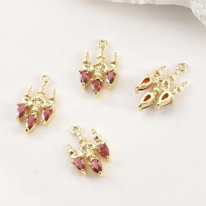 Set of four gold-plated vintage chandelier charms with red pear-shaped zircon stones