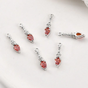 Detailed set of silver vintage pendants with drop-shaped red zircons and retro relief