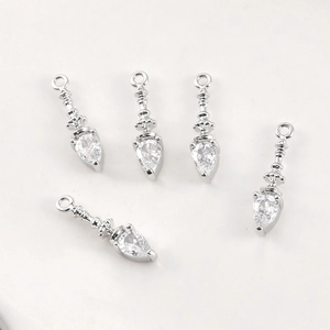 Macro shot of silver teardrop pendant charms with clear zircon stones for DIY jewelry