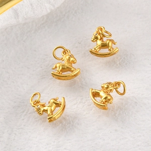 Macro view of four golden rocking horse pendants with matte finish and white zircon eye