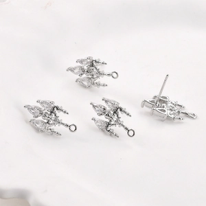 Macro detail of 14k gold plated copper ear studs with clear pear shaped zircon stones