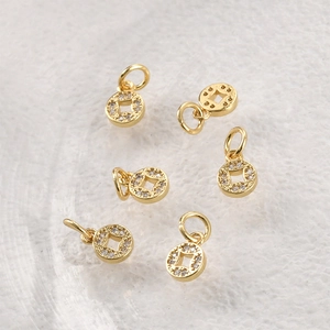Close-up of set of 6 gold-plated round coin pendants with hollow square centers and zircons