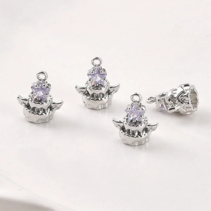 Détail macro de quatre pendentifs gâteau argentés avec gemmes étoiles violettes