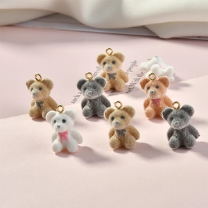 Detailed view of multi-colored flocked bear charms with gold metal rings for DIY jewelry