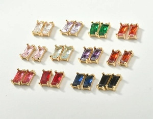 Detailed macro view of 12 colors of rectangular crystal charms with 18k gold plated frames