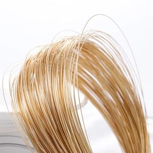 14k gold-filled jewelry wire for DIY handmade jewelry crafts on white marble background