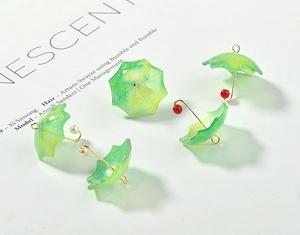 Macro detail of acrylic umbrella pendants with green-yellow gradient and glitter finish