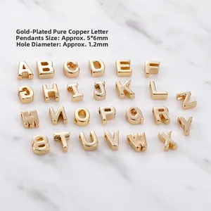 Detailed macro view of 18k gold plated copper alphabet beads for DIY jewelry making