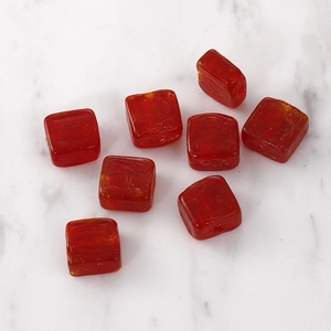 Macro shot of red translucent square glass beads for DIY jewelry making and necklaces