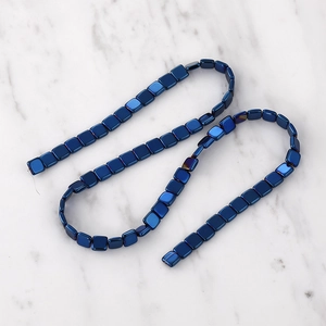 Macro shot of deep blue square hematite beads for DIY jewelry with metallic finish