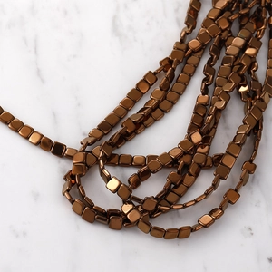 Close-up of square metallic bronze hematite spacer beads for DIY jewelry making