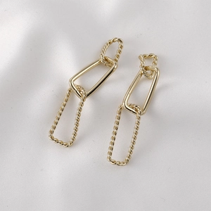 Elegant 14k gold plated rectangular twisted chain earrings on white silk background