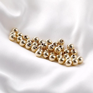 Polished 14K gold plated loose beads on white silk for DIY jewelry making and crafts
