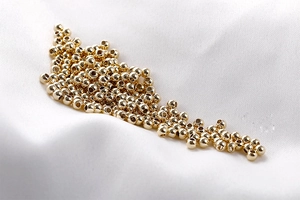 Close-up of polished 14K gold-plated spacer beads for DIY jewelry making