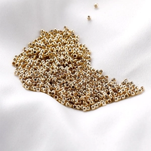 Macro view of polished 14K gold-plated spacer beads for DIY jewelry making accessories
