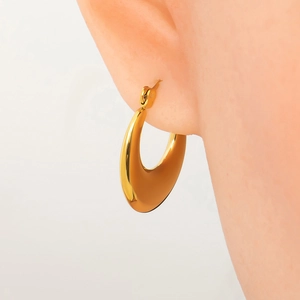 Macro view of 18k gold plated chunky hoop earrings with polished tapered metal texture