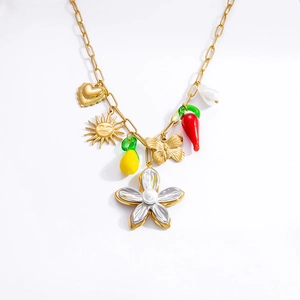 Detailed view of bohemian gold chain necklace with colorful flower and fruit charms